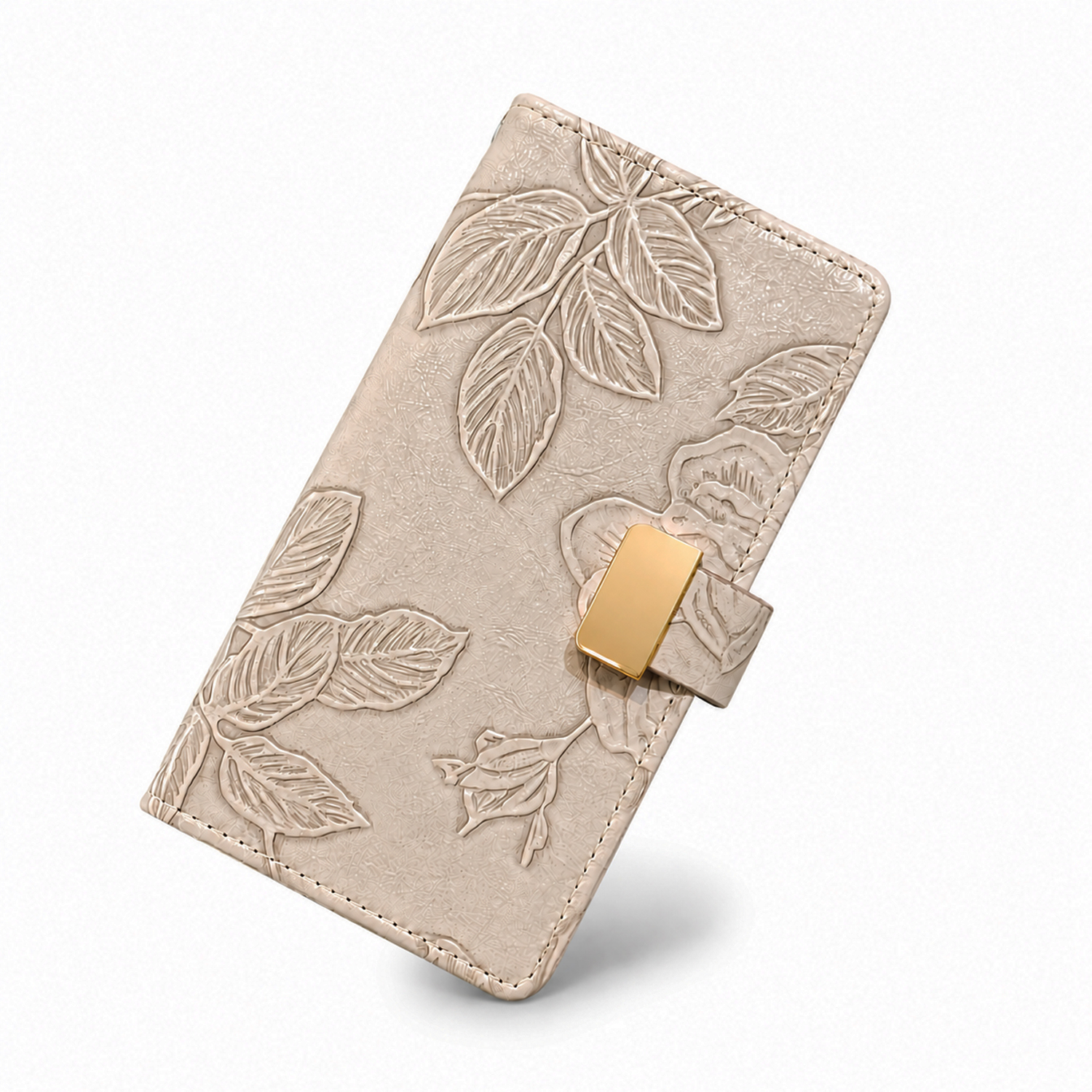 Embossed floral folio phone cases displayed on a soft fabric background with metallic clasp design. Beige floral embossed wallet phone case with card slots holding metallic cards and a smartphone inside. embossed leather phone case showing the magnetic cl